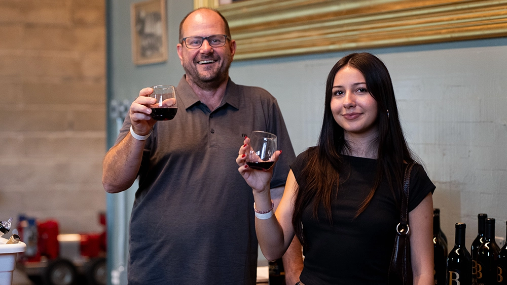 Two people raising a glass of Biane Wine